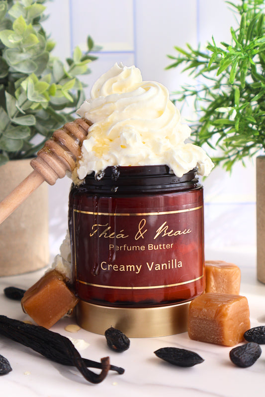 Creamy Vanilla perfume body butter in jar with whipped cream, vanilla beans and caramel accents