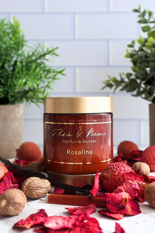 Rosalina perfume body butter in our luxury jar on white surface with lychee nutmeg and rose petals