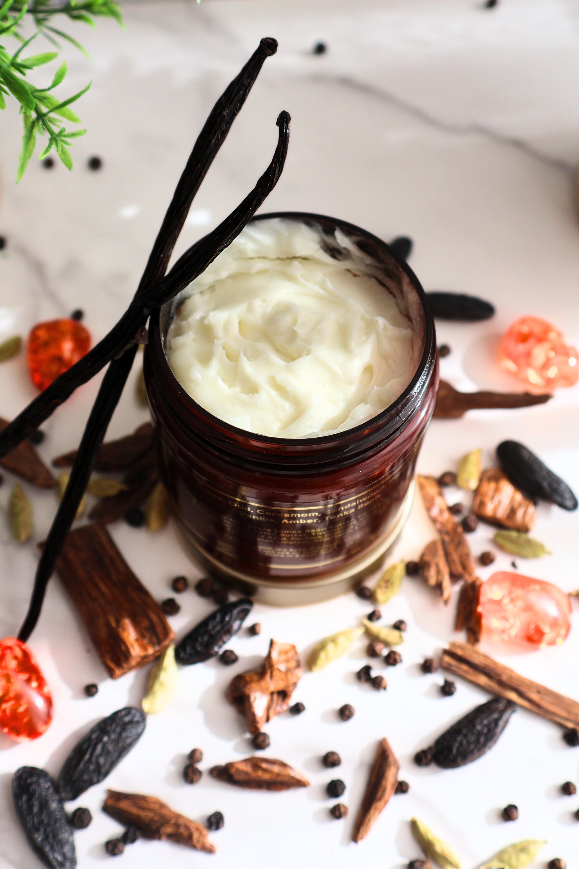 Luxury Woody Oud perfume body butter overhead view showing rich smooth texture and vanilla bean and woody accents